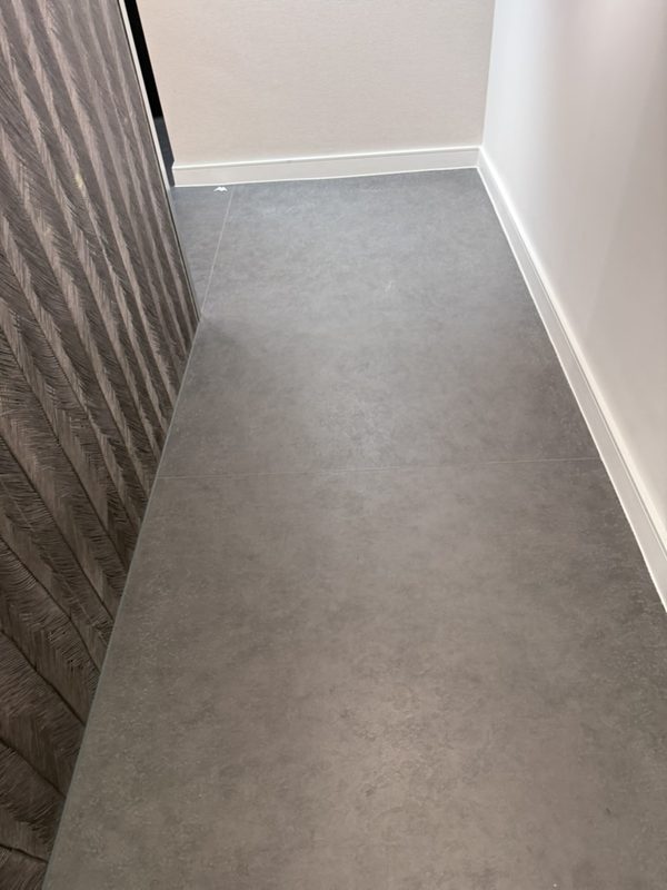Clean commercial corridor floor and skirting boards.