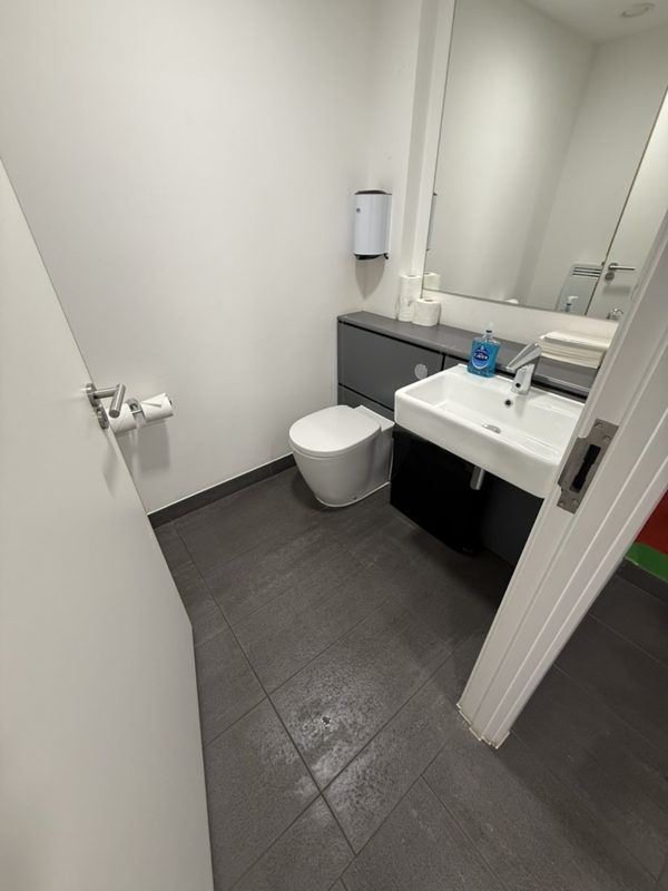 Clean gym washroom with sanitised toilet and basin.