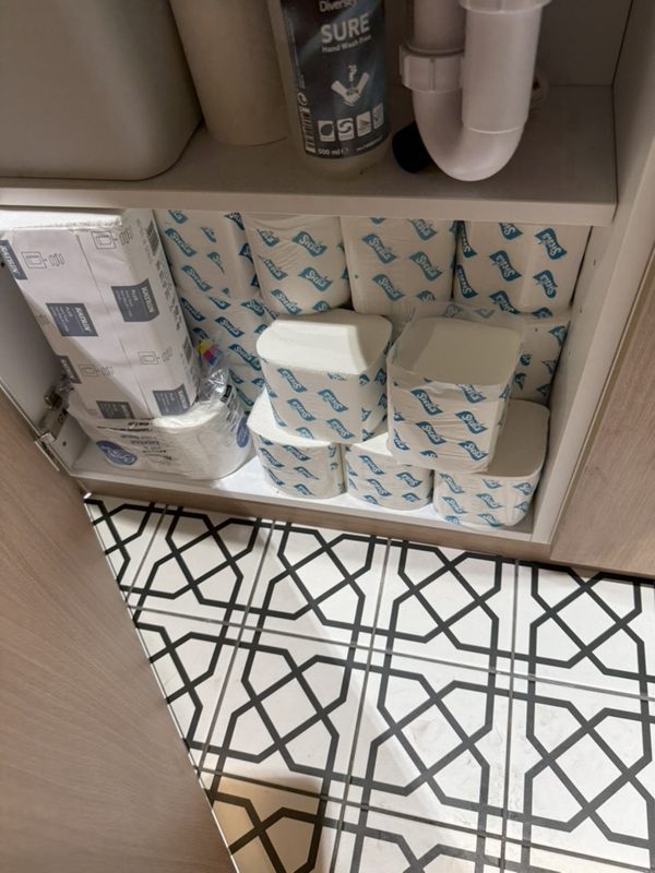 Organised washroom consumables ready for restocking.